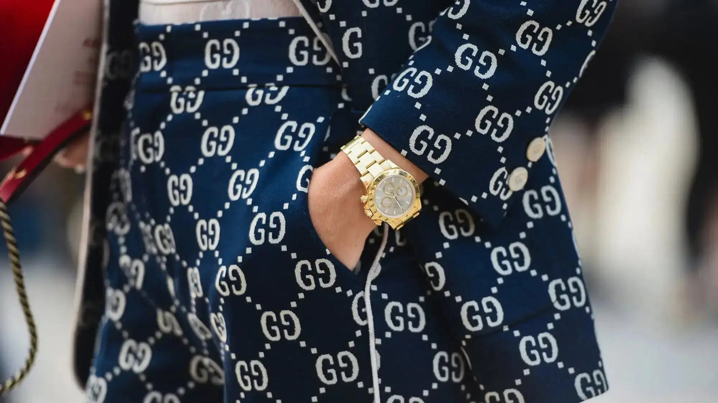 Gold-tone luxury watch on wrist in designer shopping article