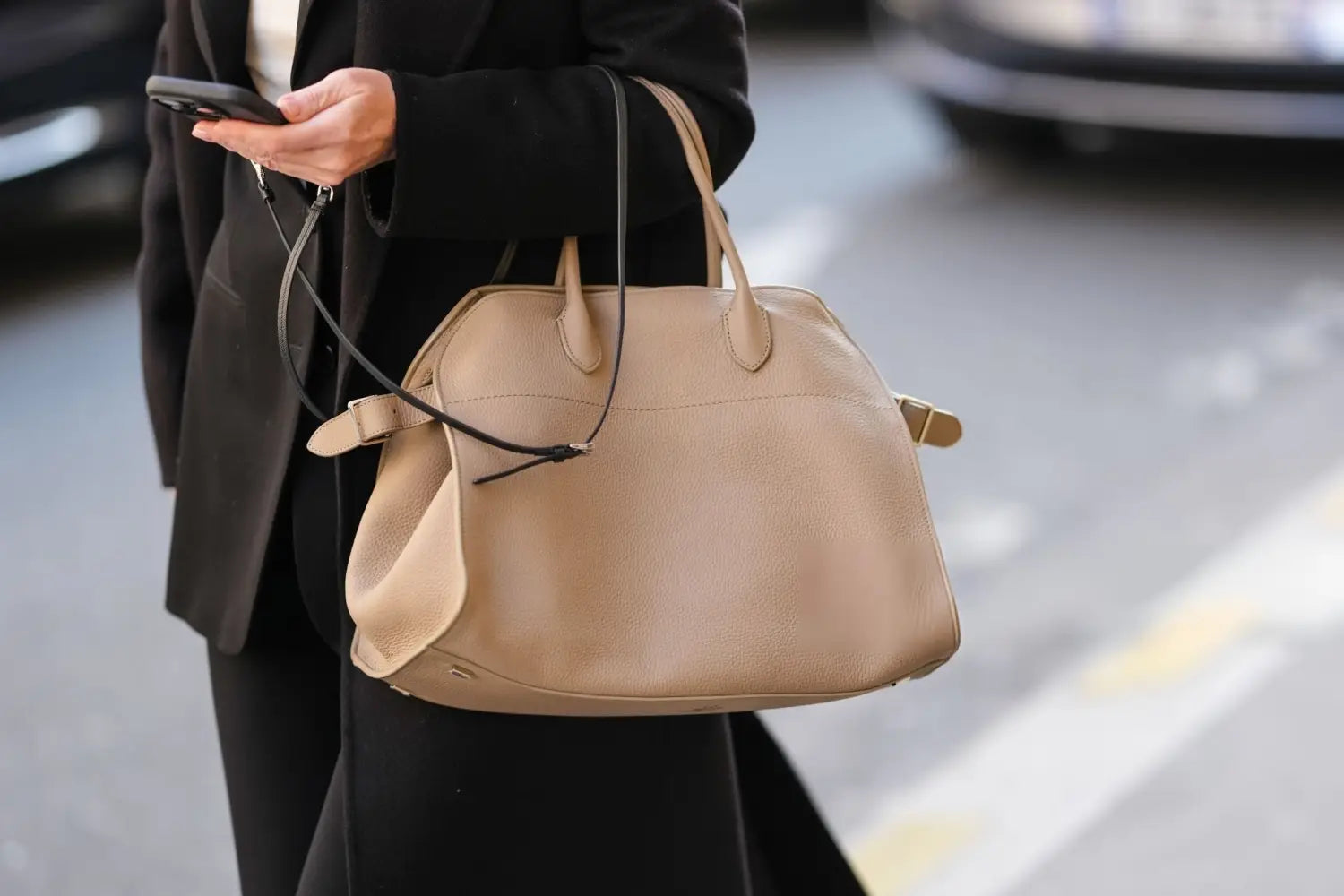 Beige leather satchel with top handles and detachable black strap