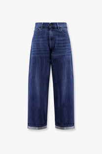Dark blue denim 3x1 women’s skater boyfriend jeans with high waist wide legs and rolled cuffs revealing lighter fabric