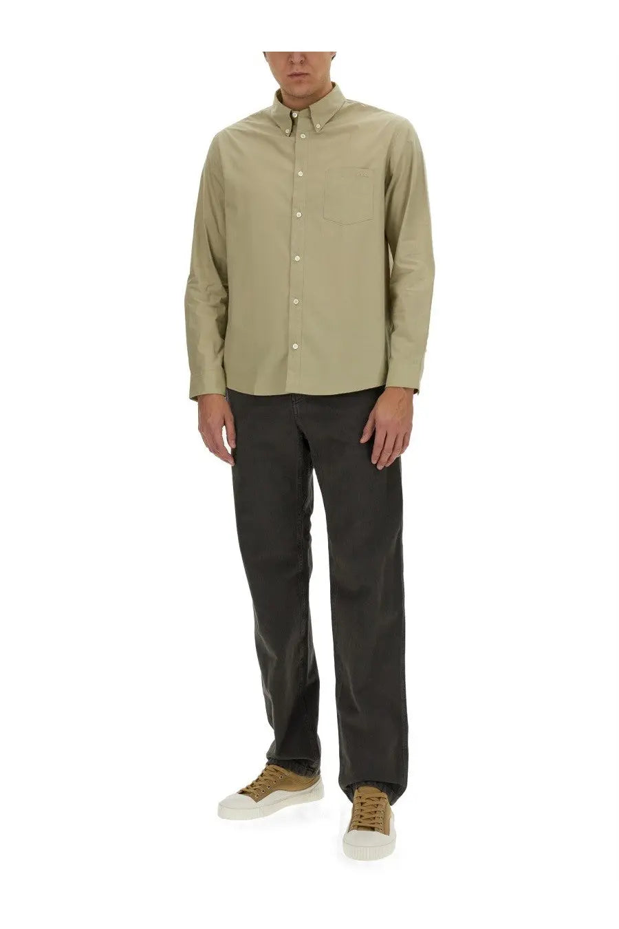 A beige long-sleeved button-down shirt with a classic collar paired with a.p.c men’s chuck grey pants