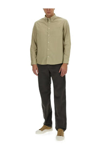 A beige long-sleeved button-down shirt with a classic collar paired with a.p.c men’s chuck grey pants