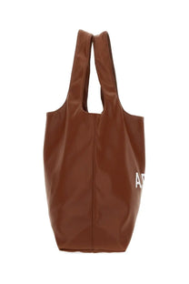 Brown faux leather tote bag with white lettering on the side from A.P.C women’s Borsa tote Ninon Brown collection