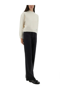 Cream-colored long-sleeved knit sweater with ribbed crew neckline and hem paired with a.p.c women’s elizabeth jeans black