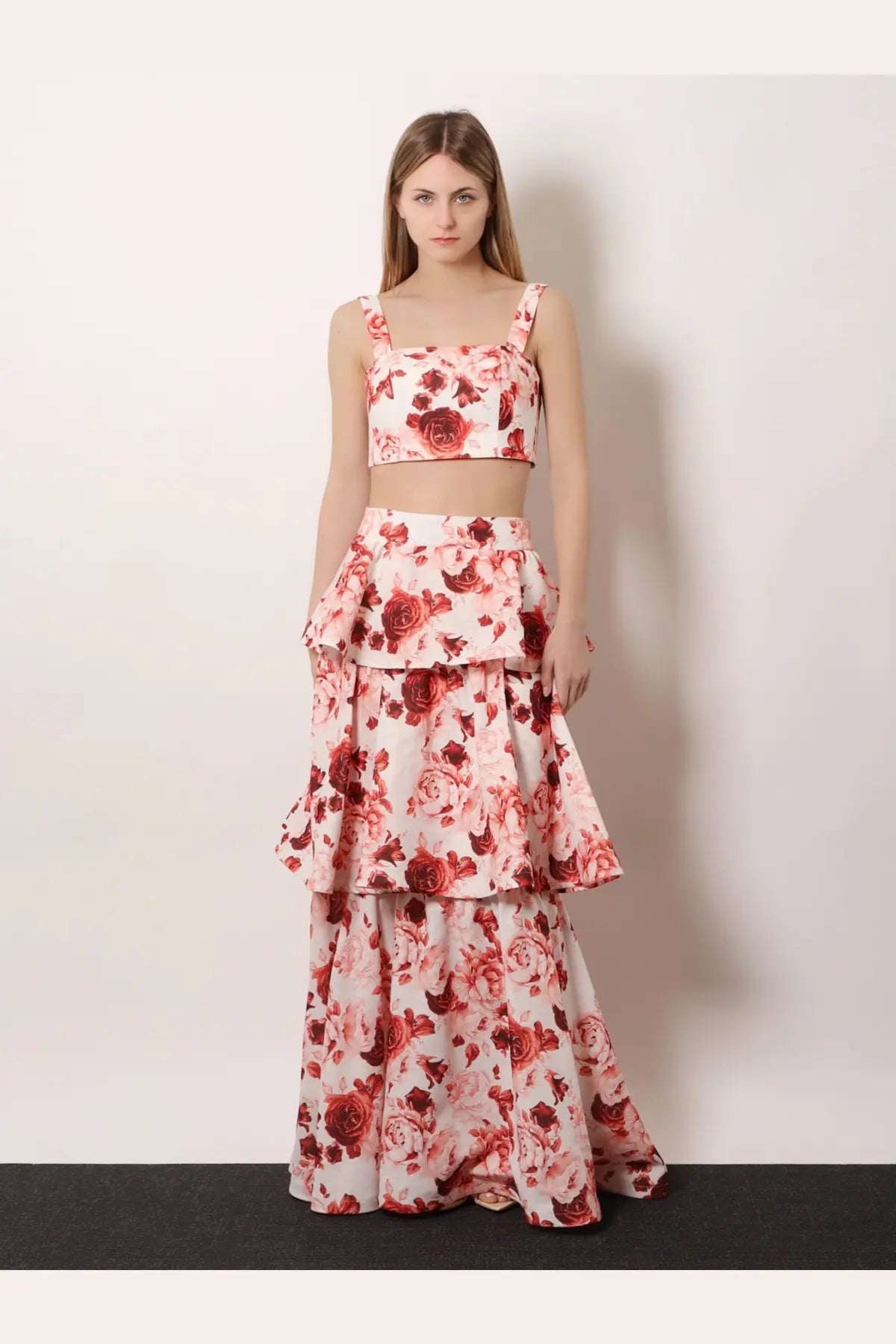 A woman wears actualee women’s flounced long skirt pink with a white crop top featuring red rose prints and floral pattern