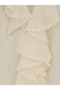 Actualee women’s shirt white with cream-colored ruffled fabric and delicate white pom-pom trim along each layer