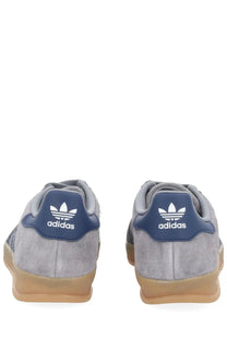 Adidas men’s gazelle indoor sneaker grey with gray suede, navy blue heel tabs, white branding, and tan rubber sole