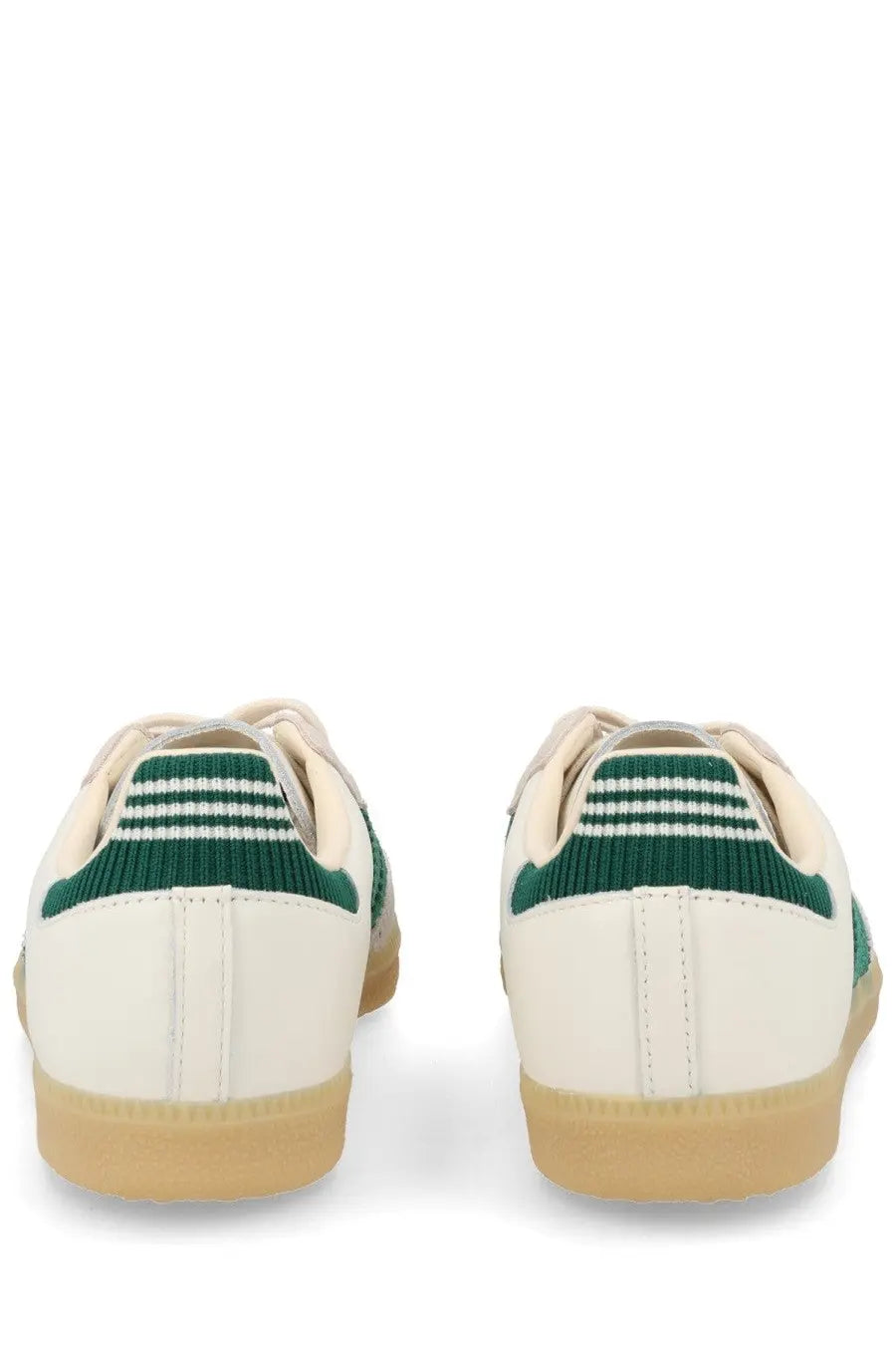Cream-colored adidas men’s sneaker samba with green knit heel tabs and three white stripes