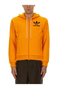 Bright orange adidas originals by wales bonner men’s hooded track sweatshirt with black logo and white drawstrings