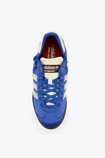 Vibrant royal blue adidas x les bonner sneakers with white three-stripe detailing and black rubber sole