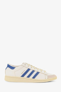 Cream-colored leather adidas Originals x Willy Chavarria men’s Chavarria Jabbar dress sneaker with blue stripes and heel tab