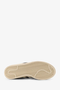 Beige rubber sole with distinctive herringbone tread on adidas originals x willy chavarria men’s black nylon sneakers