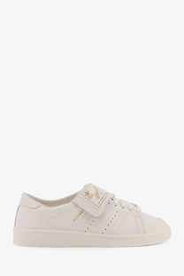 Cream-colored adidas Originals x Willy Chavarria leather superstar sneakers with velcro strap and gold side detailing