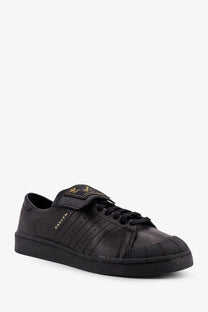 Adidas Originals x Willy Chavarria men’s black leather superstar sneaker with gold branding and velcro strap