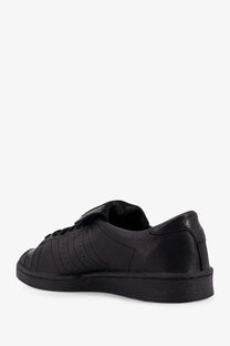 Adidas Originals x Willy Chavarria men’s black leather sneaker with classic three stripes and rubber toe cap