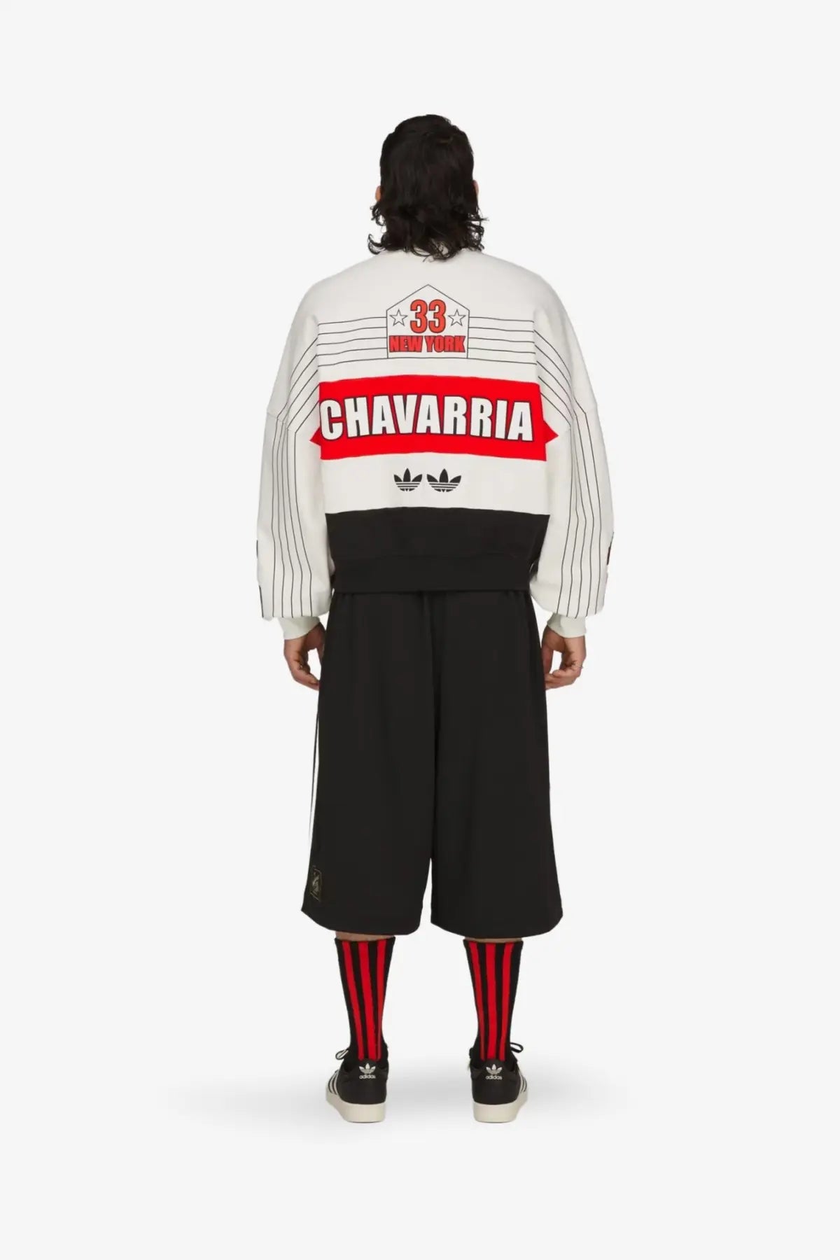 Back of adidas originals x willy chavarria white and black striped bomber jacket with red chavarria graphic and vintage sports design
