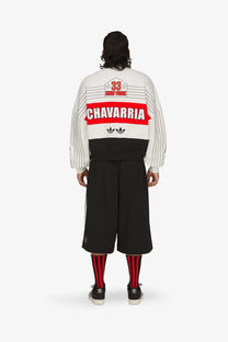 Back of adidas originals x willy chavarria white and black striped bomber jacket with red chavarria graphic and vintage sports design