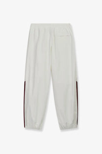Adidas Originals x Willy Chavarria men’s cream nylon joggers with slim tapered legs and dark red side stripes