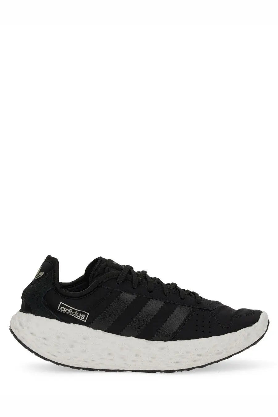 Adidas unisex zponge sneaker black running shoe with white textured sole and three black stripes on the side