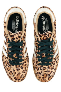 Adidas women’s samba OG sneaker with leopard print, white stripes, and dark green laces in leather material