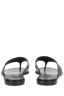 Aeyde women’s black leather thong sandals with minimalist design and flat sole for casual wear