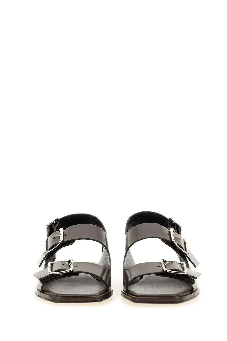 Aeyde women’s black patent leather sandals with silver-toned buckle straps visible from the back side