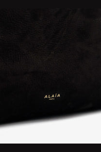 Alaïa women’s le click pocket nabuk shoulder bag in black textured leather with gold foil alaïa paris branding