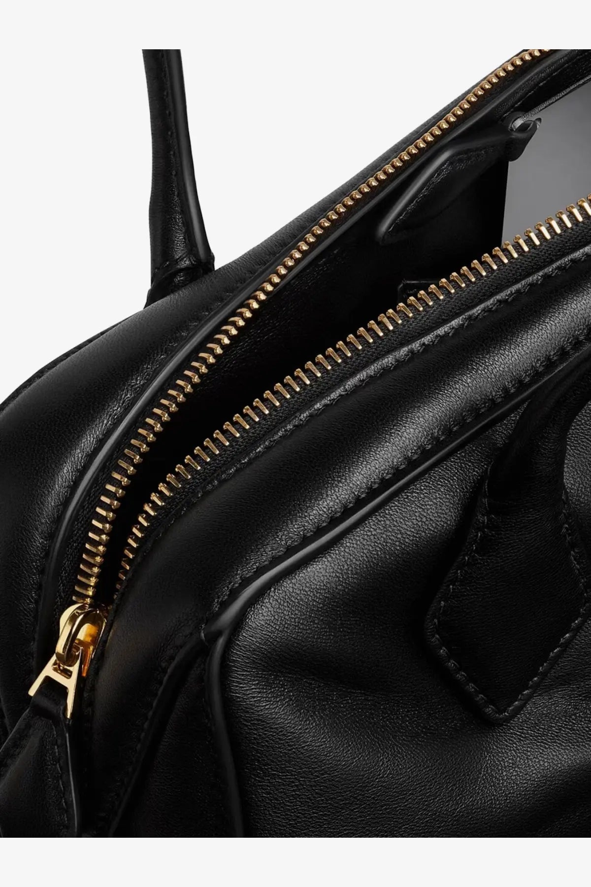 Alaïa women’s le teckel black leather shoulder bag with gold tone zipper and hardware shown from the back side