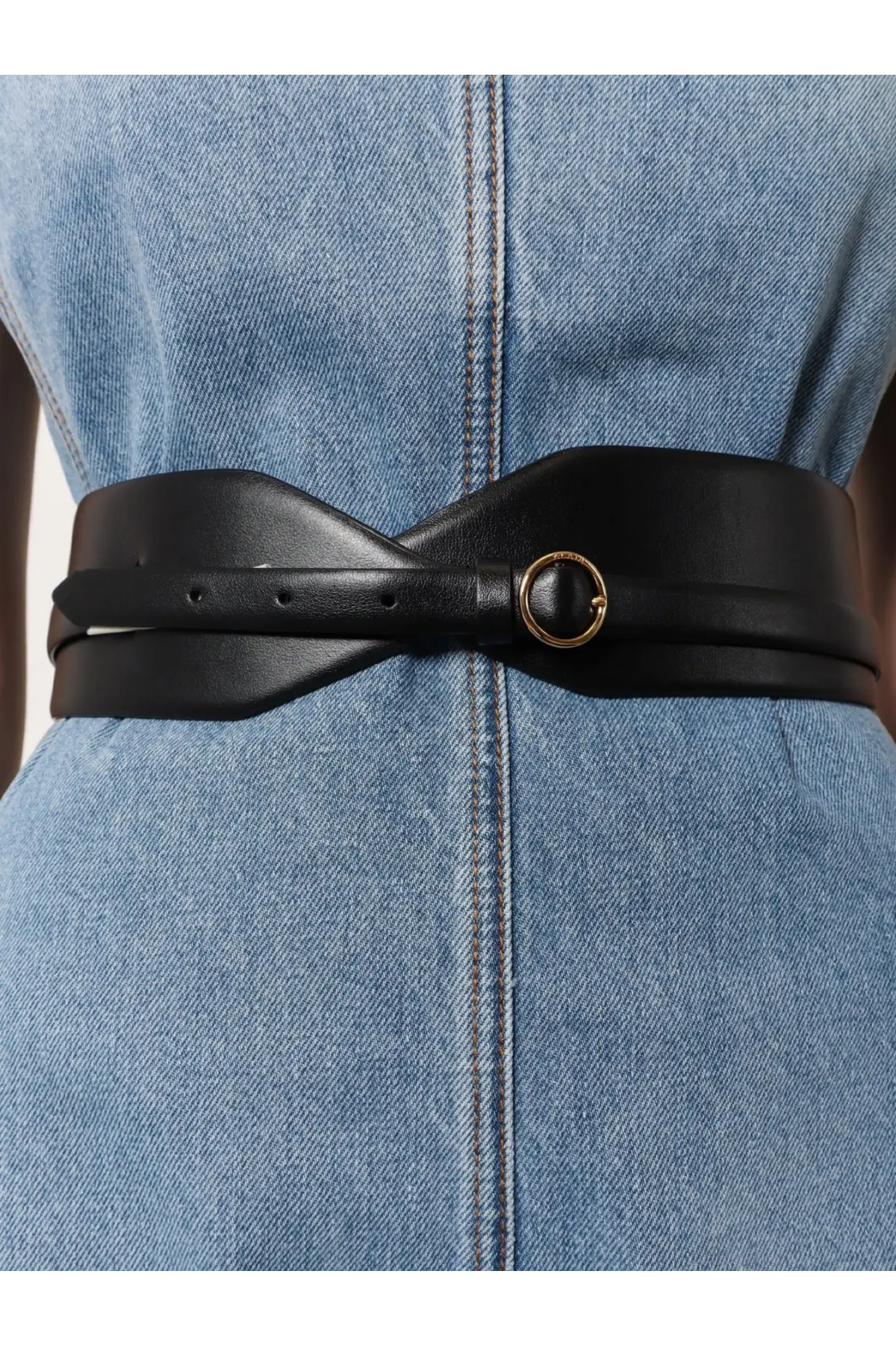 Alaïa women’s black leather belt with a sleek twisted design and a gold toned circular buckle