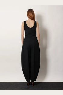 Alaïa women’s black round virgin wool sleeveless jumpsuit with wide flared legs shown from the back side
