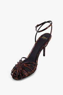 Alevi women’s blake tortoiseshell leather high-heeled sandal with slender ankle strap and crisscross design in brown