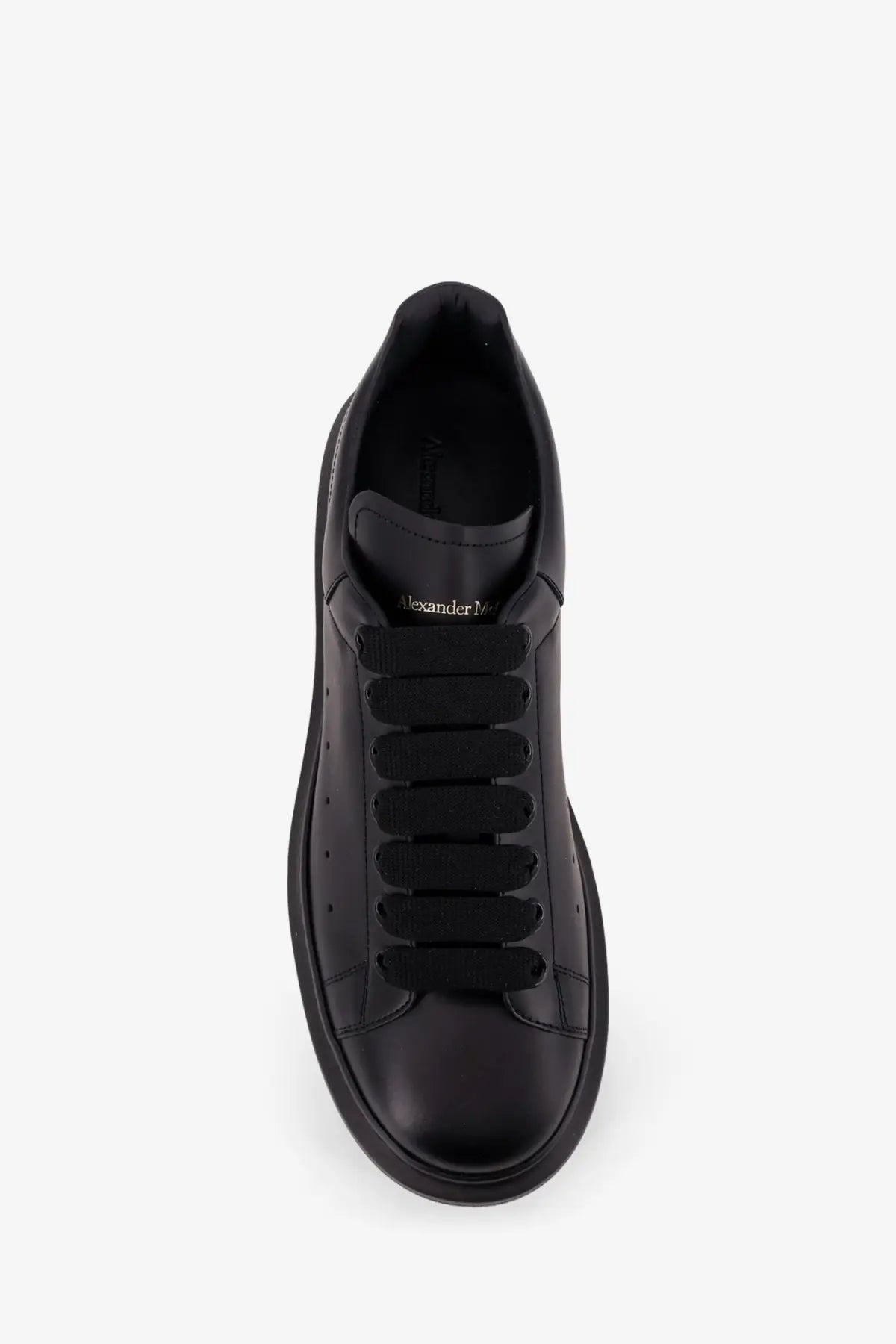 Alexander McQueen men’s black leather sneakers with thick soles and elastic laces for casual wear