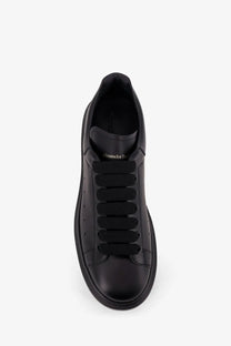 Alexander McQueen men’s black leather sneakers with thick soles and elastic laces for casual wear