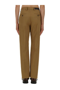 Back view of tan Alexander McQueen men’s trousers with a straight-leg cut and buttoned rear pockets