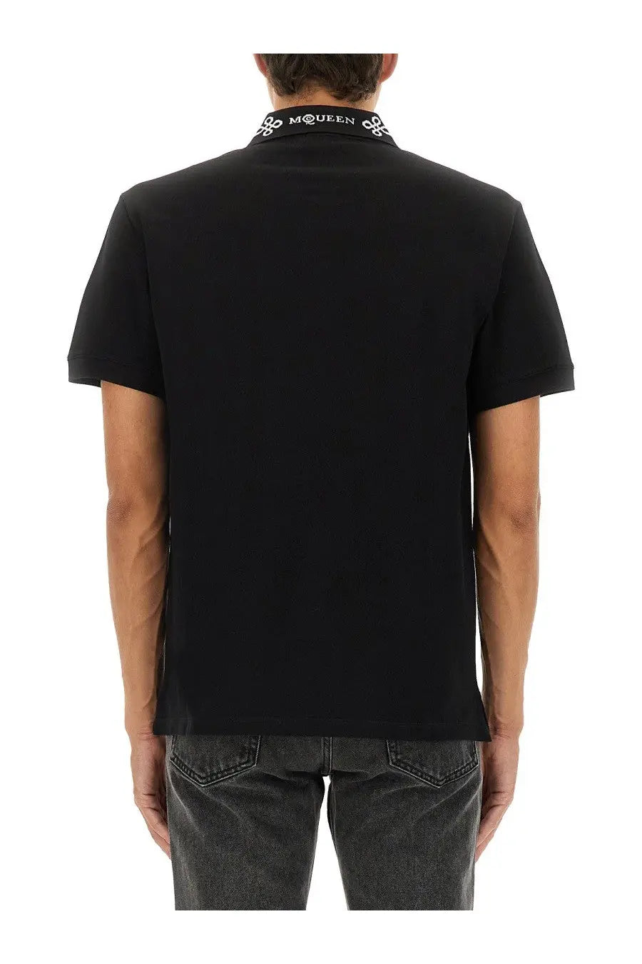 Alexander McQueen men’s black short-sleeved polo shirt with white embroidered mcqueen logo and decorative collar pattern