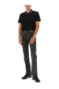 Alexander McQueen men’s black polo shirt with short sleeves and white and black striped collar trim