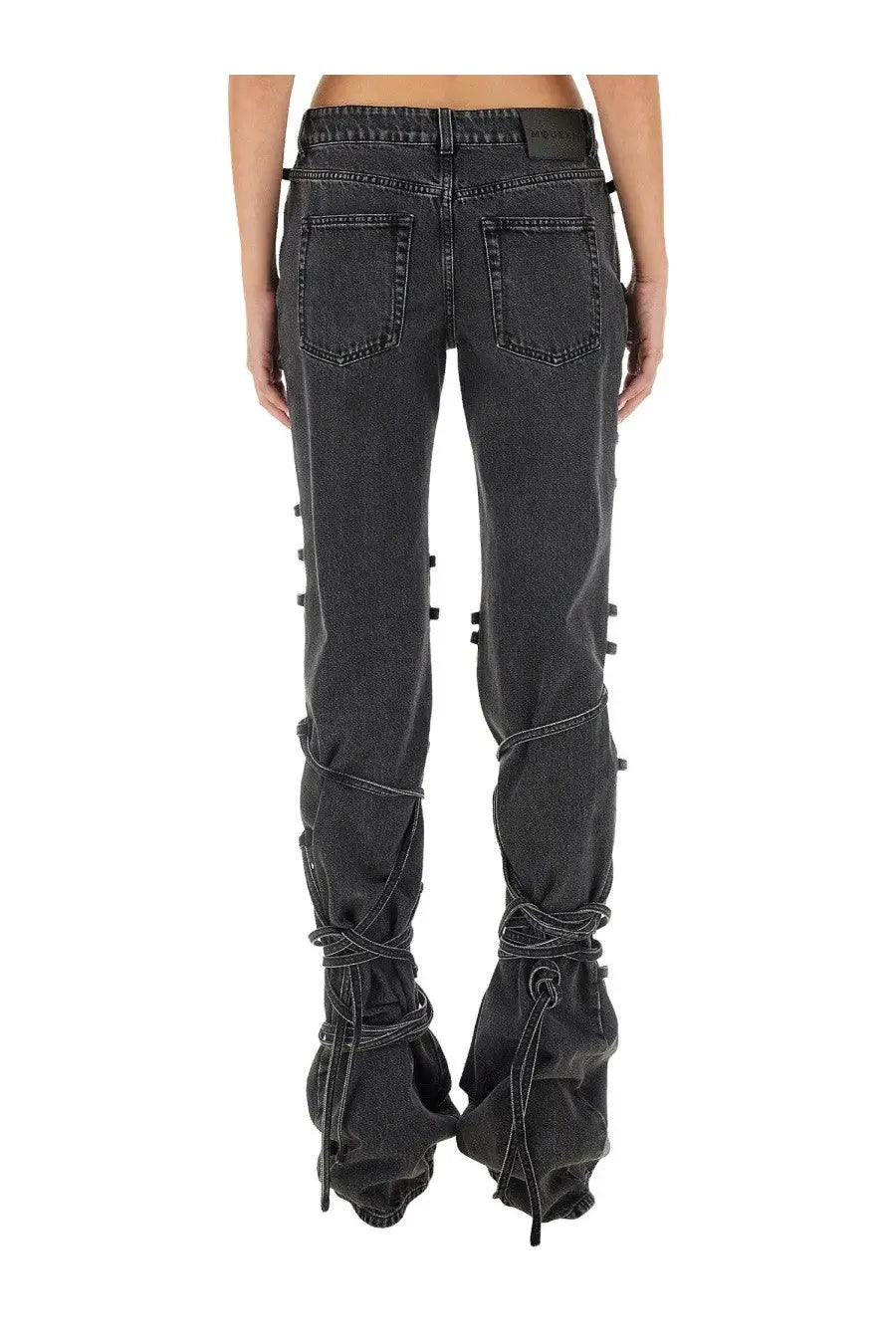 Alexander McQueen women’s black denim jeans with distinctive lace-up detailing along the lower legs