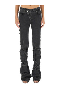 Alexander McQueen women’s black denim flare jeans with lace-up detailing along the outer legs