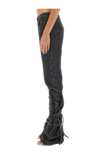 Alexander McQueen women’s black denim jeans with lace-up detailing along the lower leg front view
