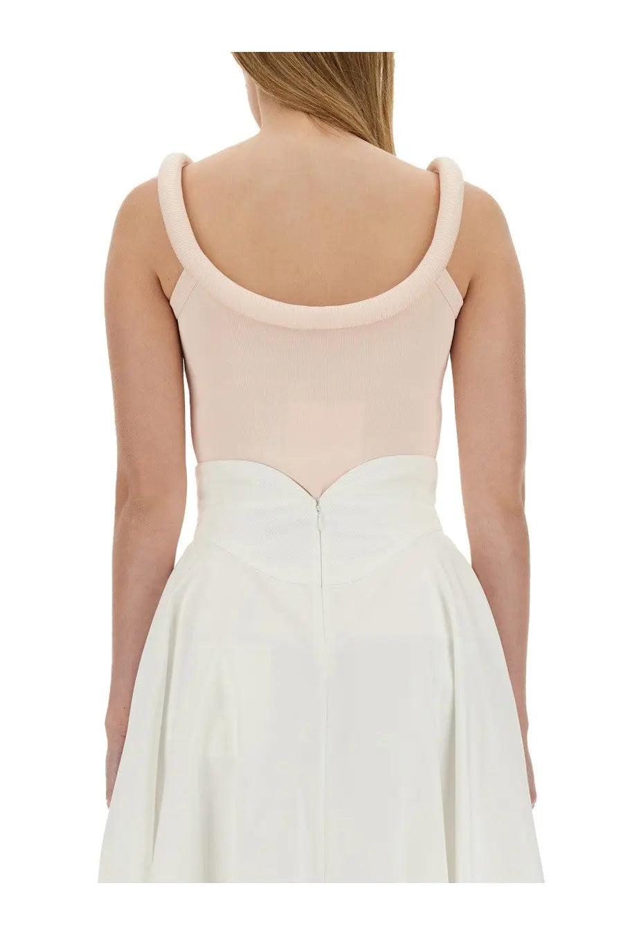Alexander McQueen women’s blush pink sleeveless top with thick straps paired with white high-waisted skirt