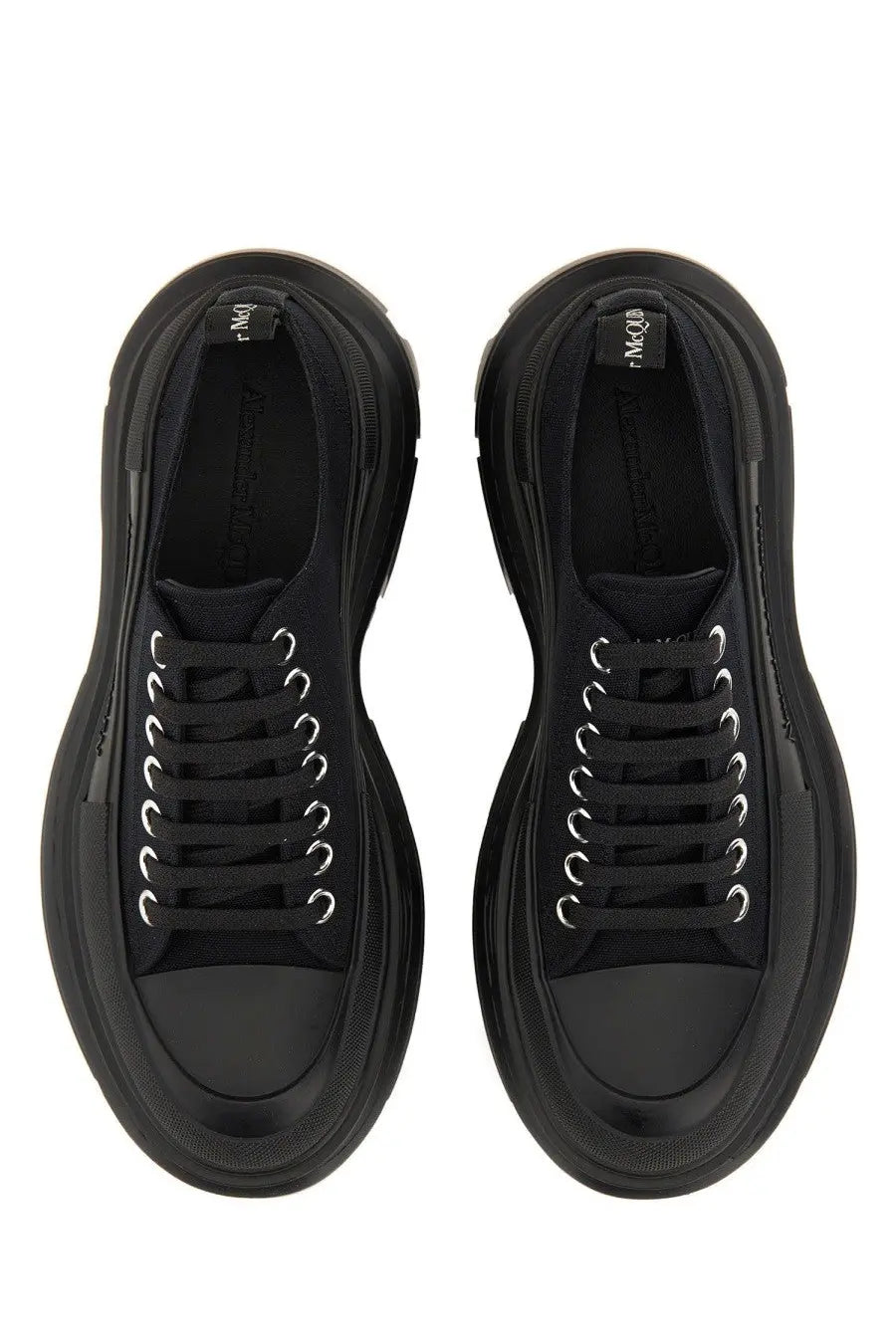 Black Alexander McQueen women’s tread slick sneaker with thick platform soles and silver toned eyelets