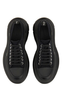 Black Alexander McQueen women’s tread slick sneaker with thick platform soles and silver toned eyelets