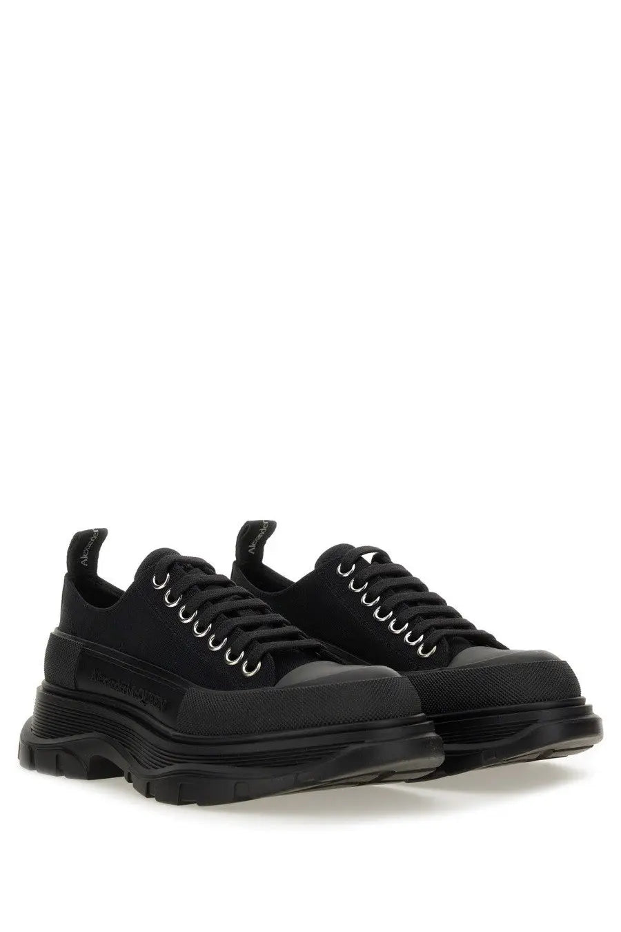Alexander McQueen women’s tread slick sneaker black with chunky soles and silver eyelets in leather material