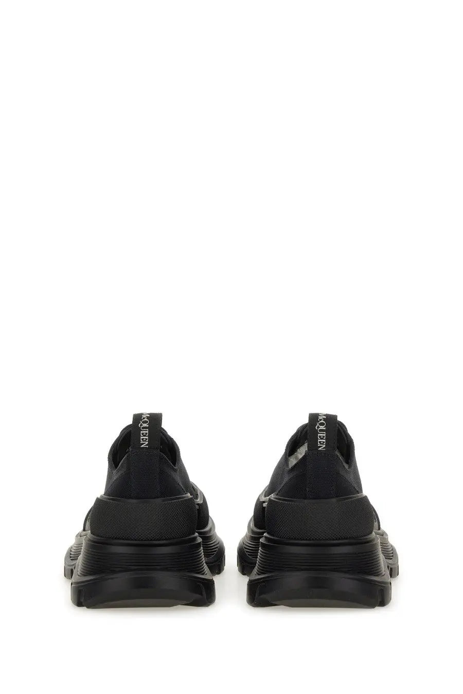 Alexander McQueen women’s tread slick sneaker black with chunky rubber sole and sleek minimalist leather design