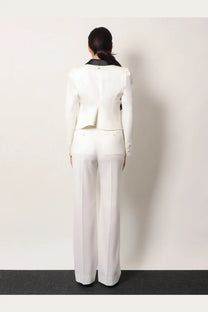 Alexander McQueen women’s white wool blazer with black collar and subtle pleating at the back shown from the back side