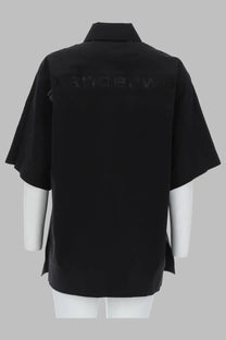 Back view of alexanderwang women’s loose fit black short-sleeved shirt with collar and subtle perforated detailing