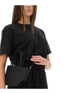 Black textured tote bag with short handles and detachable shoulder strap from alexanderwang women’s essential shirt line
