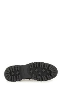 Black rubber sole with rugged textured tread and embossed cross motifs on alexanderwang womens moccasin carson brown
