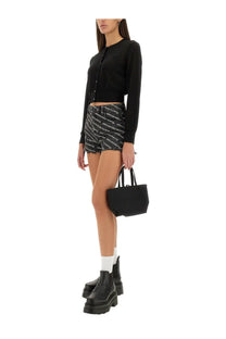 Black structured leather tote bag with top handles shown with alexanderwang women’s grey shorts