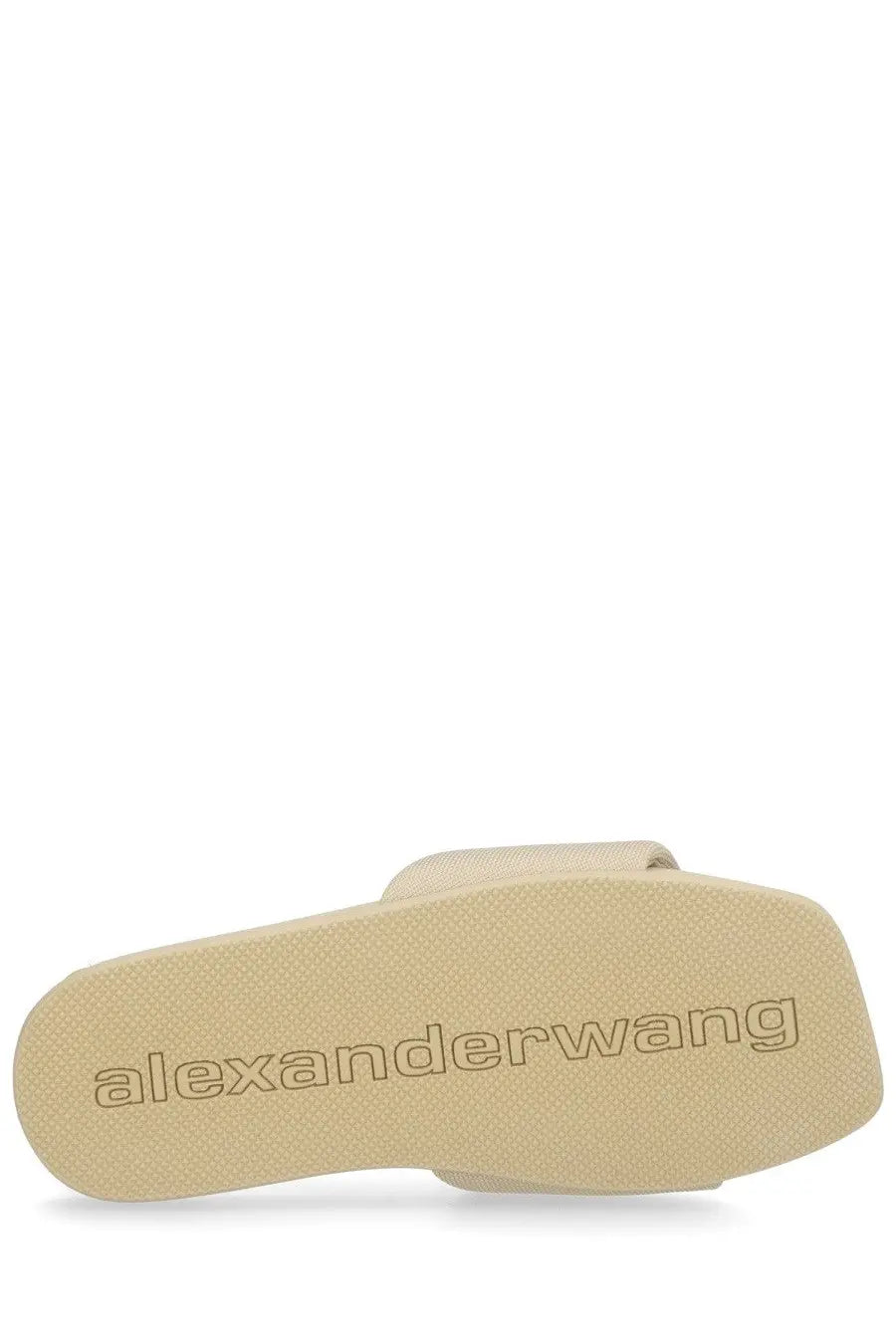 Beige alexander wang women’s slip on slide sandal with textured sole and embossed brand logo in pink style