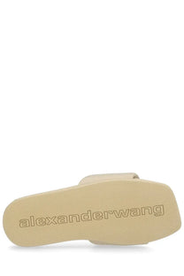 Beige alexander wang women’s slip on slide sandal with textured sole and embossed brand logo in pink style